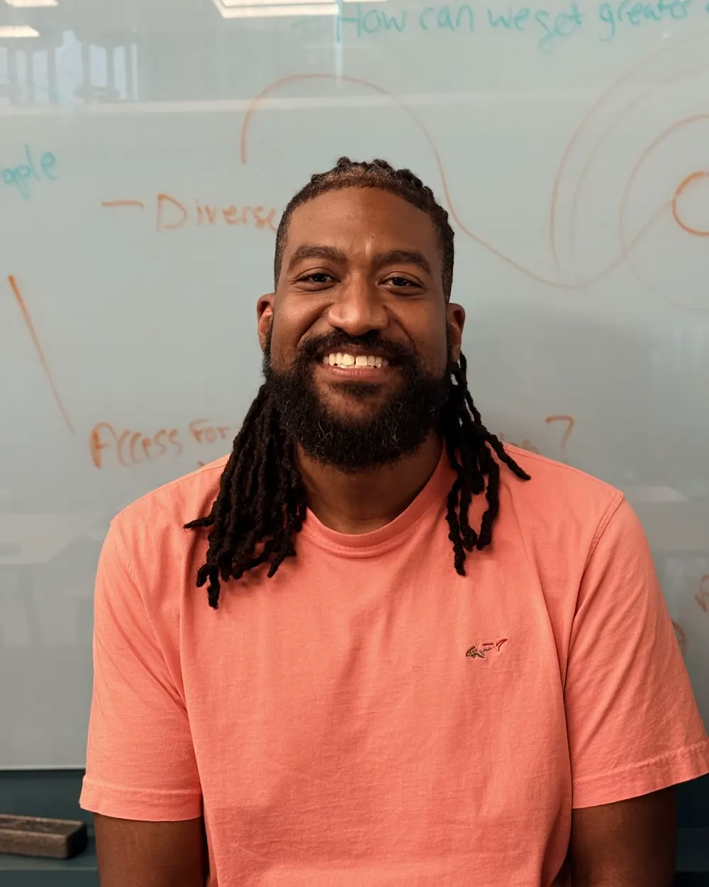 Mark Sanders, founder of FirmSideAI, smiling at a whiteboard