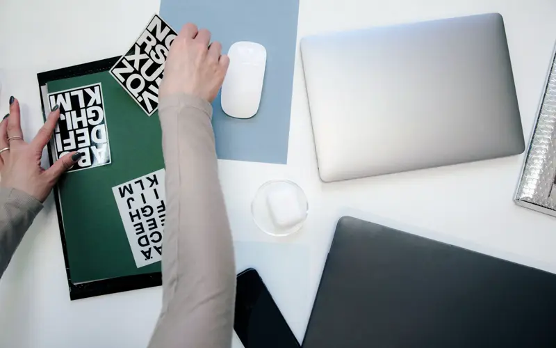 Brand posters and type samples laid out on a desk